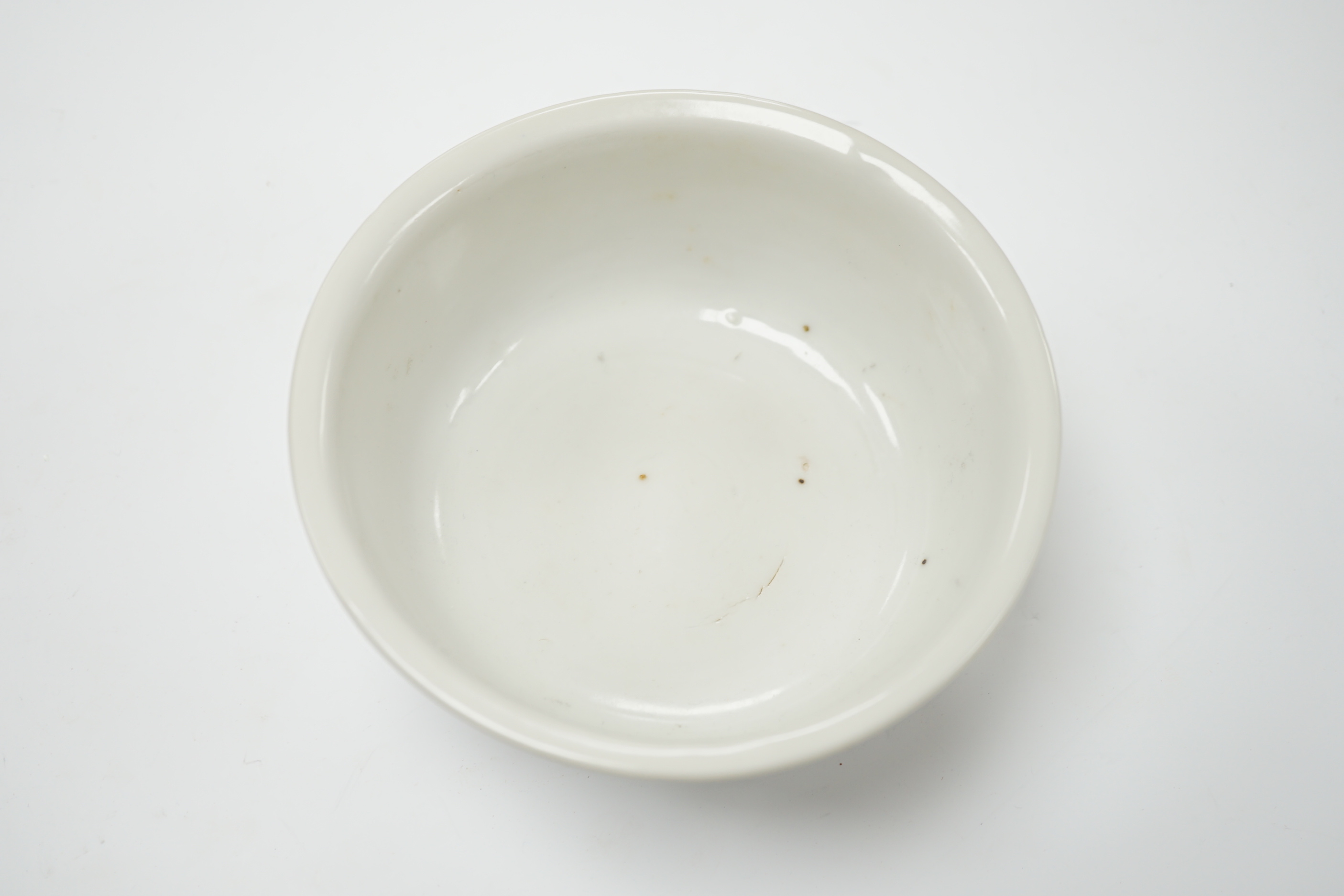 A Chinese late Ming white glazed bowl, underglaze blue seal mark, 14cm in diameter